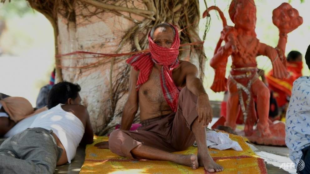 Some Delhi men escaped the heat of the day by resting in the shade of trees