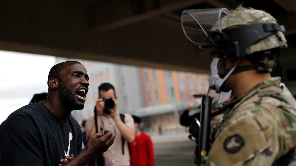 Click to enlarge man confronts a National Guard soldier