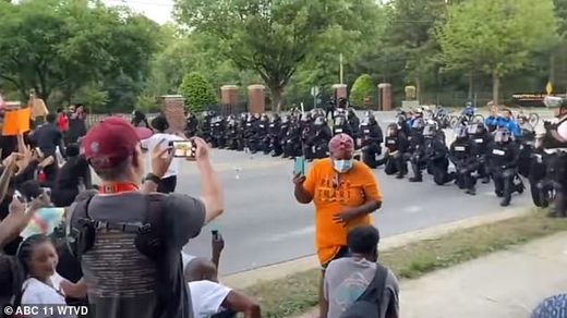 Click to enlarge Police kneel