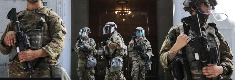 Click to enlarge National Guard troops are posted outside the district attorney's office
