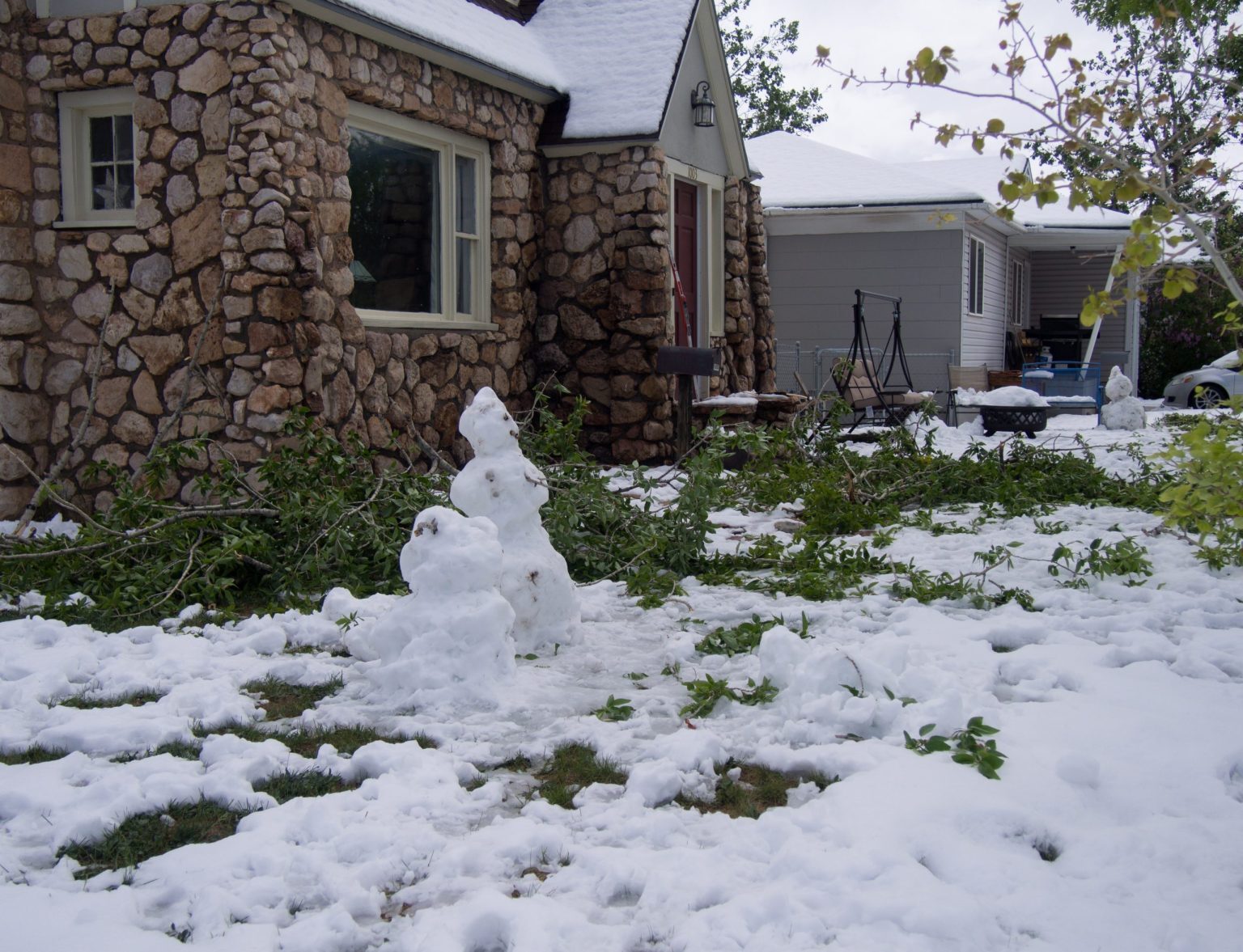 Two snowmen were built in the front yard of a home on Harney Street, using snow from a surprise snowstorm that occurred Monday in Laramie, WY.