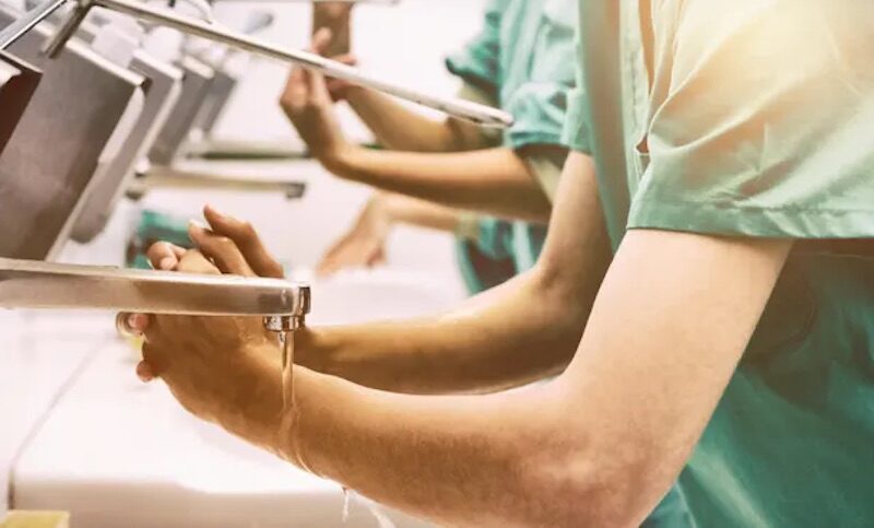 Click to enlarge Surgeons washing their hands.