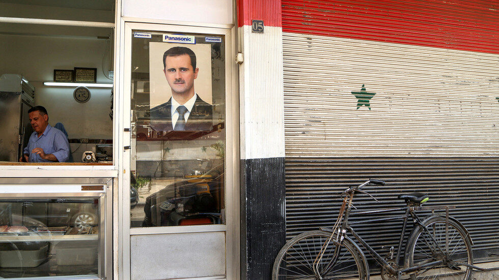 Click to enlarge Assad on a shop in Damascus