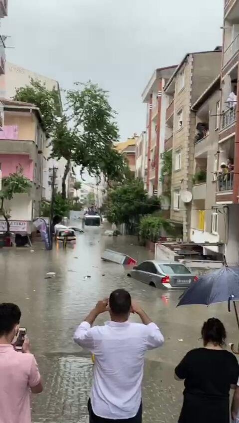 People take pictures of the flooding in Istanbul's Esenyurt, June 23, 2020.