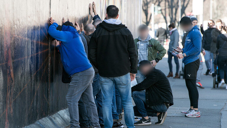 up against wall