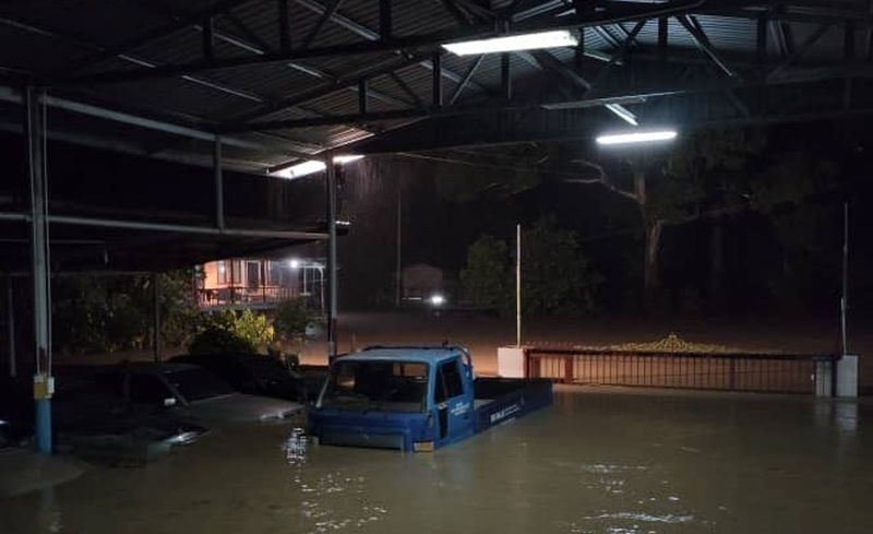 A truck is partially submerged by flood waters in Kota Belud June 28, 2020.