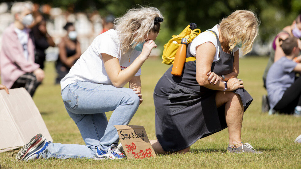 Click to enlarge Black Lives Matter demonstration, kneeling white women