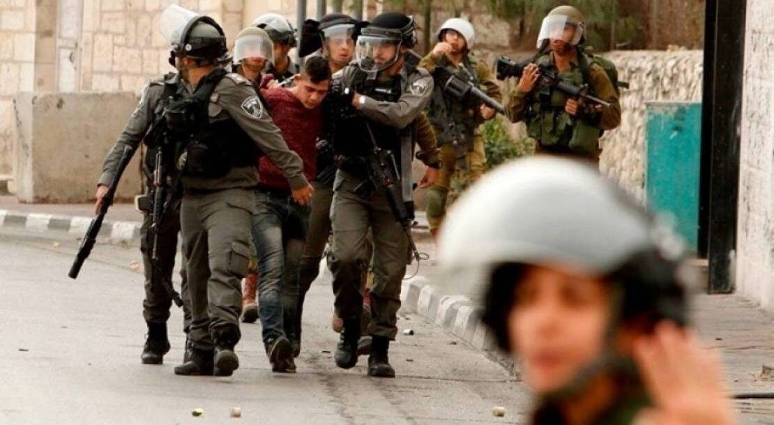Click to enlarge IDF arresting a Palestinian