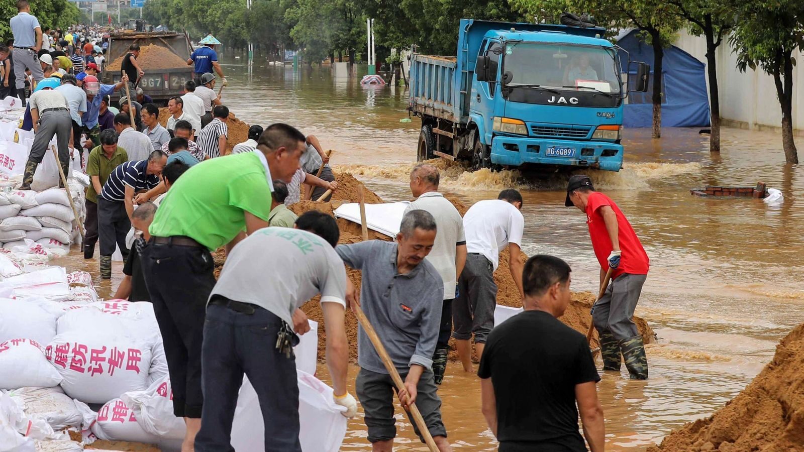 Click to enlarge Residents have been putting up makeshift flood defences