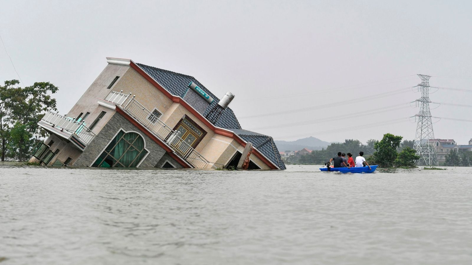 A house topples over due to the flooding in China's central Jiangxi province