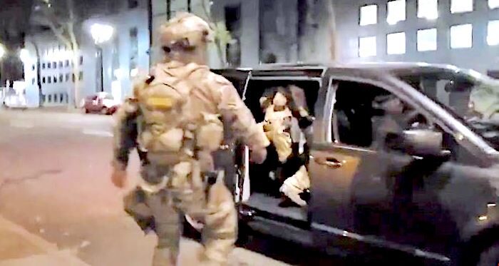 Click to enlarge Uniformed man approaches car