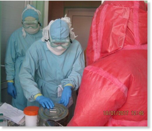Click to enlarge Biologists in protective gear at the Central Reference Laboratory