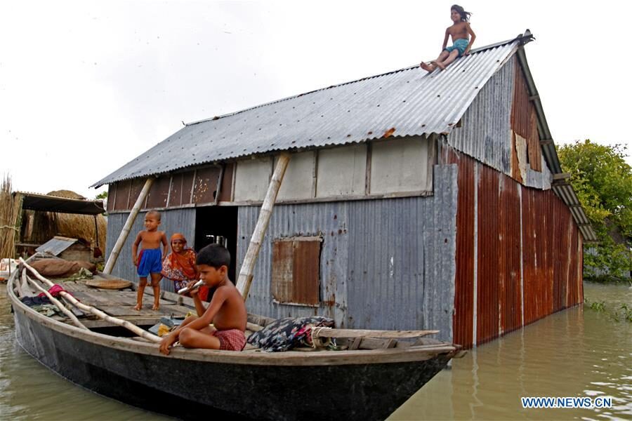 Residents are seen at their flood-affected house in Faridpur, Bangladesh, July 19, 2020.