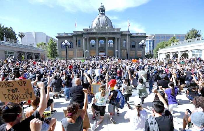 Protesters kneel