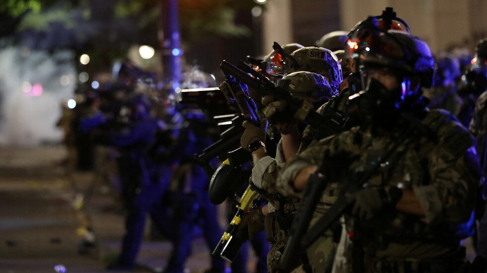 Federal law enforcement officers are seen during a demonstration against the presence of federal law enforcement officers and racial inequality in Portland, Oregon, U.S.