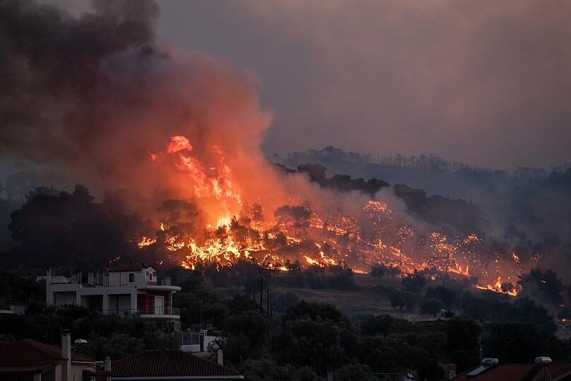 Fire burns near the village of Galataki as authorities evacuate the place near Corinth, Greece. July 22, 2020
