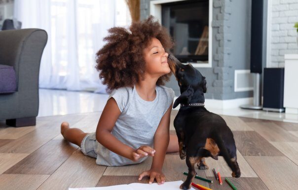 Child playing with puppy