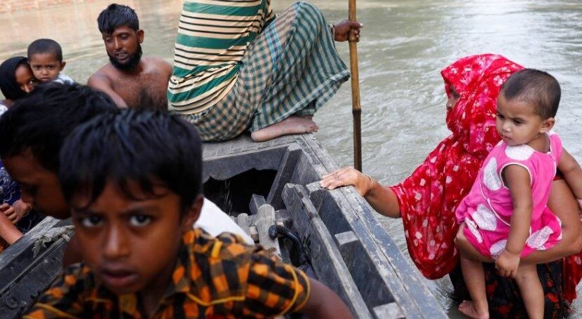 Click to enlarge Flood-affected people get on a boat
