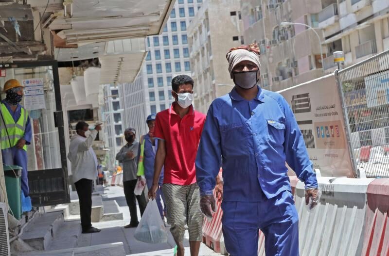 Click to enlarge Workers in Doha