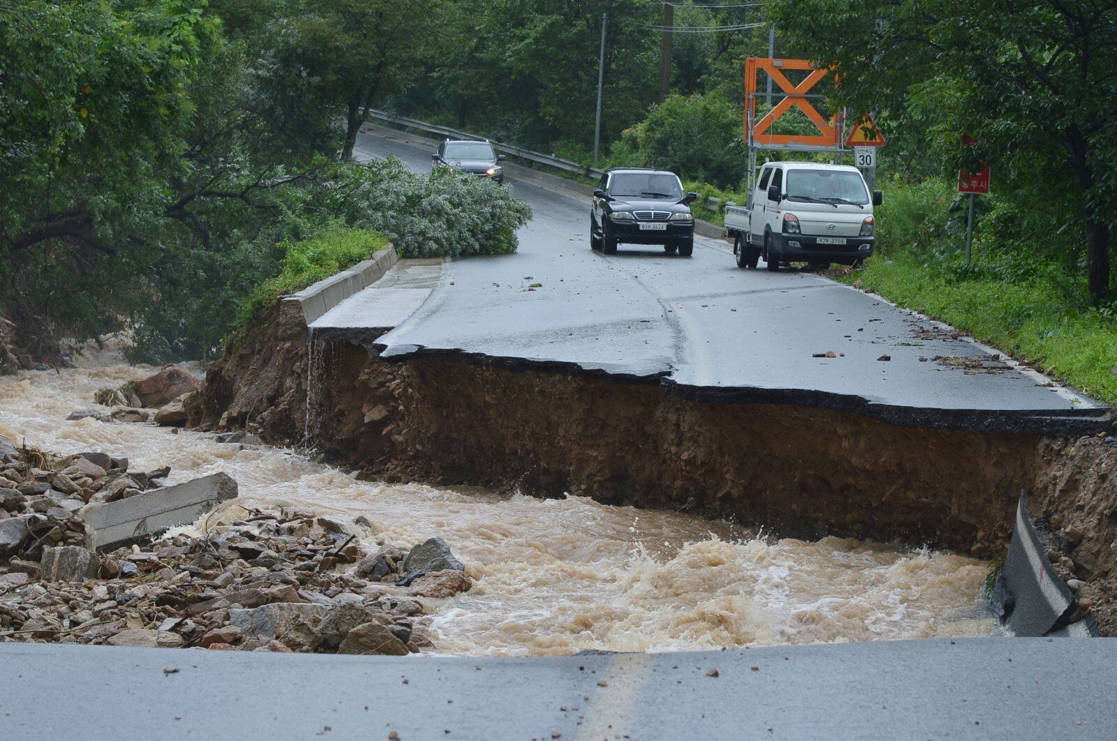 Collapsed road due to heavy rain in Chungju on August 2.