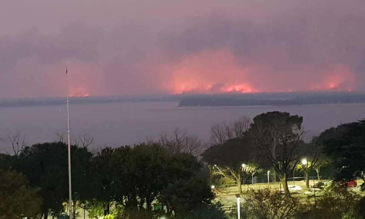 Click to enlarge Pillars of fire across the river from Rosario.