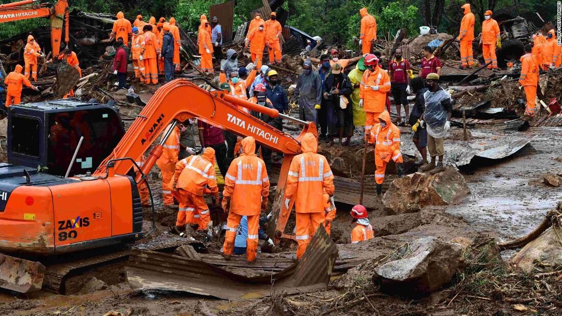Rescue workers search for missing people at a landslide site caused by heavy rains in Pettimudy, in Kerala state, on August 8, 2020.