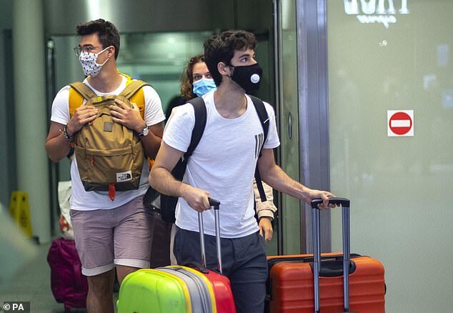 Passengers are seen returning from France to St Pancras Station