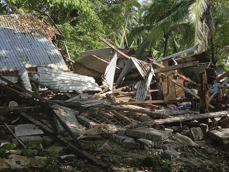 Click to enlarge A toppled house is seen after a quake struck in Cataingan, Masbate.