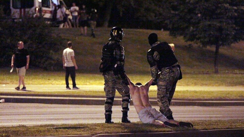 Riot police detain a protester, Minsk