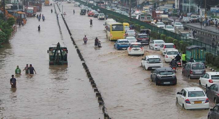 Vehicles ply on waterlogged Delhi-Gurgaon Expressway near Narsingpur after heavy rains, in Gurugram
