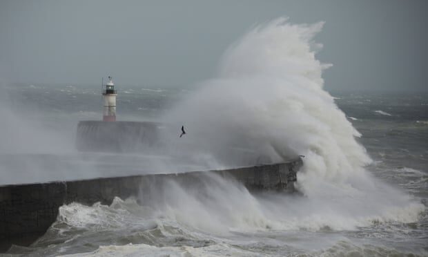 Waves crash against the harbour wall in Newhaven, England