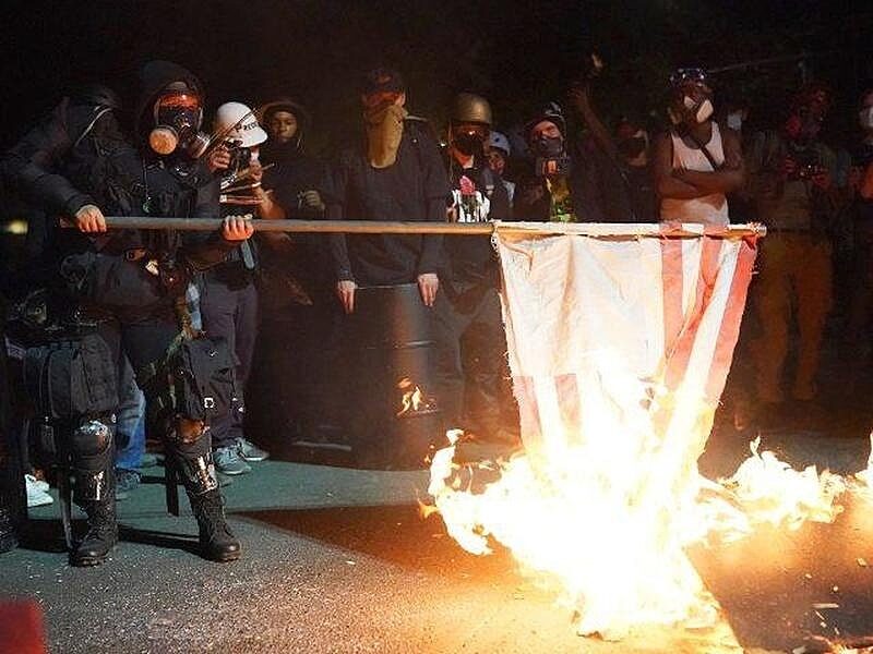 portland protesters burn flag