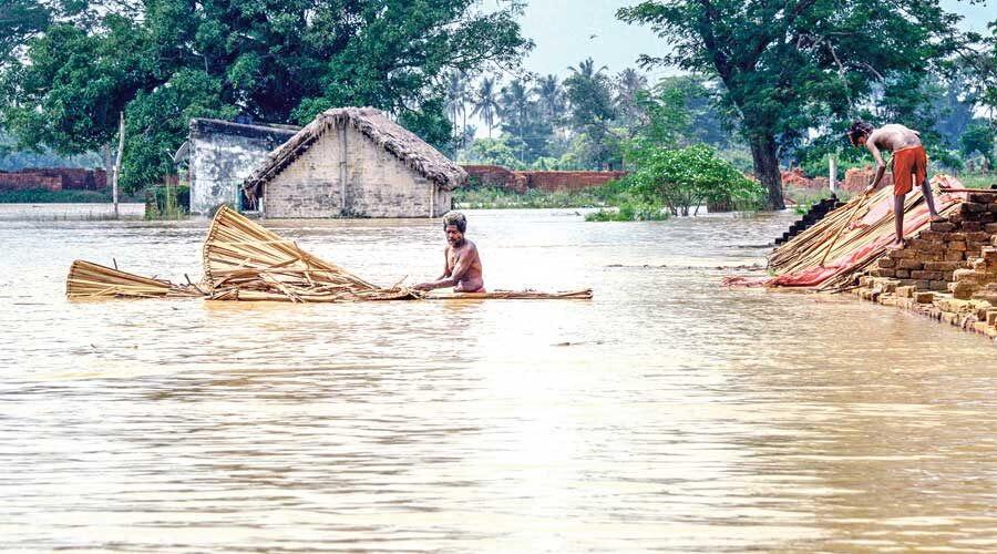 Click to enlarge Residents shift from a flooded village near the banks of river Bhargavi in Odisha’s Khordha district on Saturday.