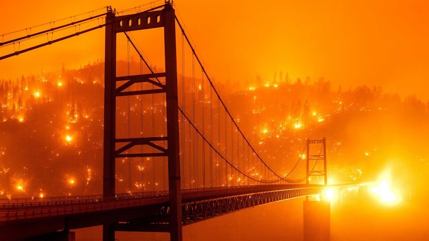 Fires light up a hillside behind the Bidwell Bar Bridge in Oroville, California