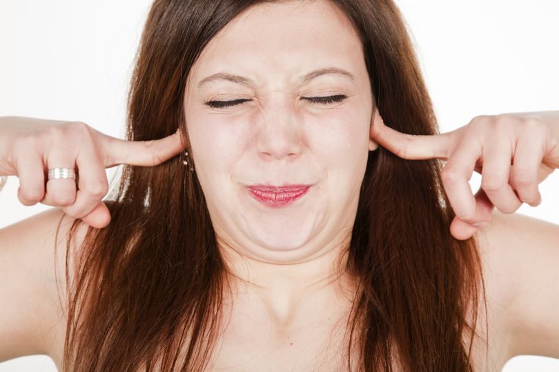 Woman covering ears