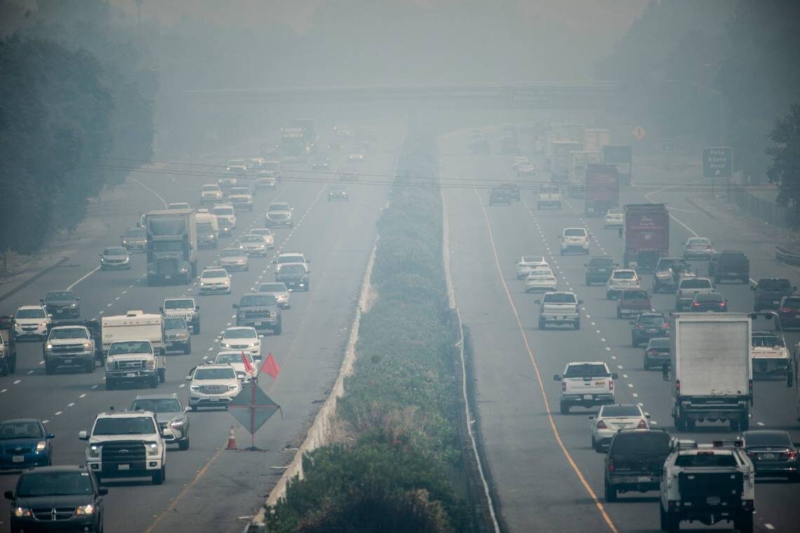 Vehicles on Interstate 80 in Vacaville drive through smoke from California’s wildfires on Monday, Aug. 24, 2020.