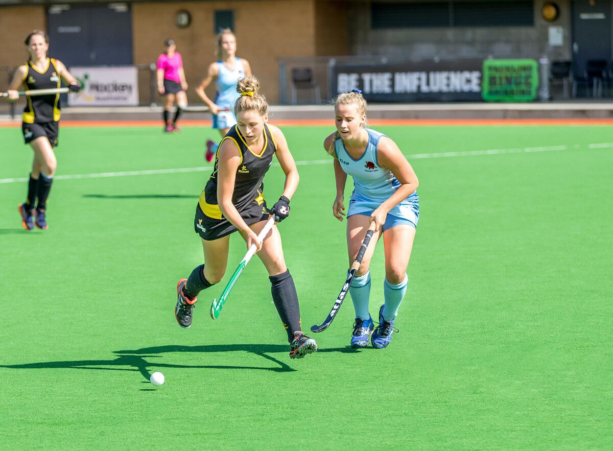 Click to enlarge Women playing field hockey