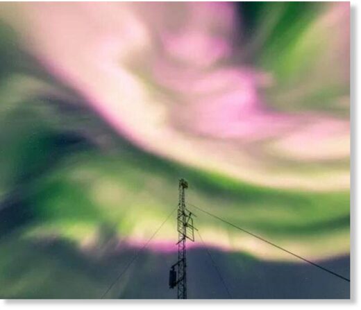 The northern lights appear pink over Tromso, Norway, on Saturday night.