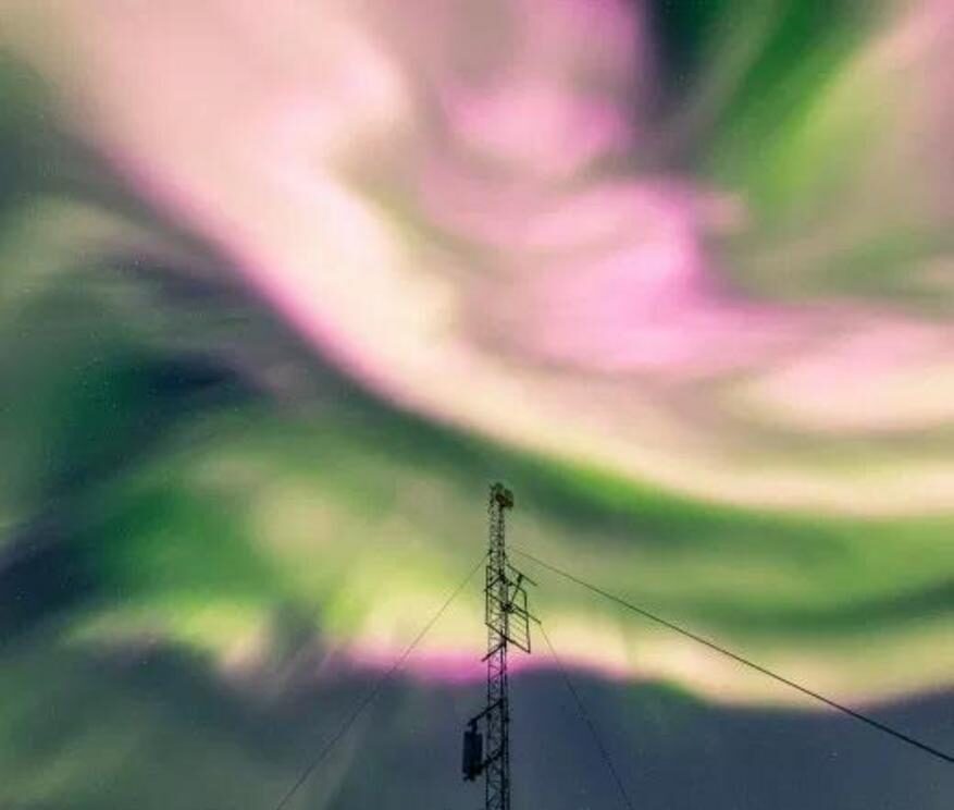 Click to enlarge The northern lights appear pink over Tromso, Norway, on Saturday night.
