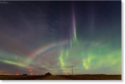 A moonbow appears against a backdrop of emerald-green northern lights over Castor, Alberta, on Sunday night
