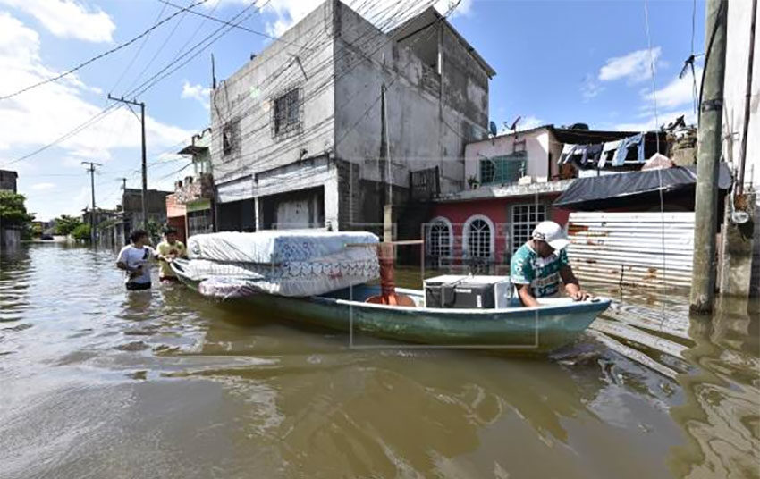 Flood victims salvage their belongings from flooded homes in Tabasco.