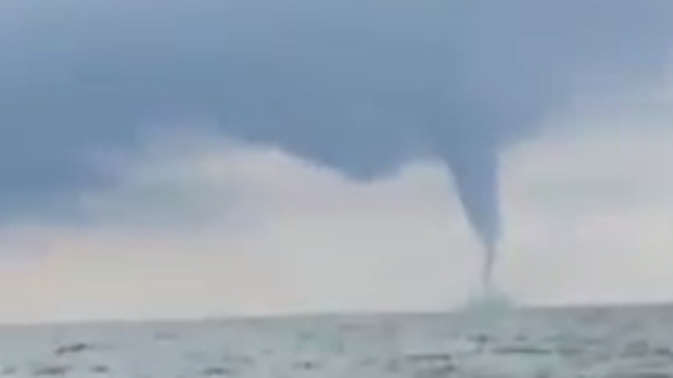 Two fishermen watched as a waterspout developed before their eyes over Lake Erie