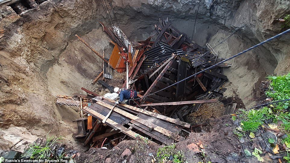 Two people were rescued but search teams are still looking for a 78-year-old woman who was believed to be inside the house when it was swallowed by the sinkhole