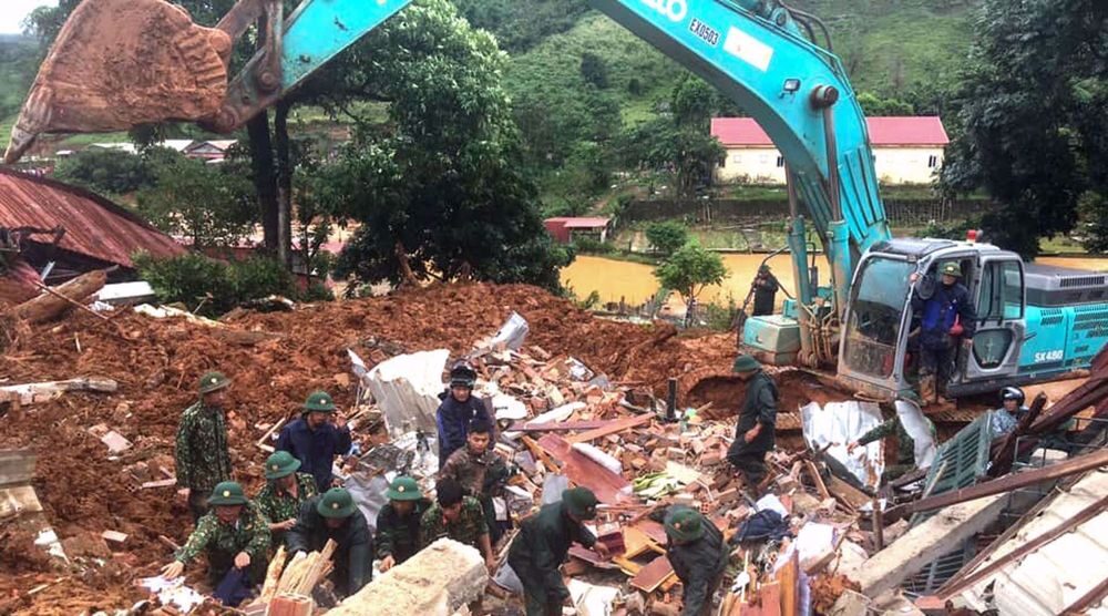 Click to enlarge This picture taken on October 18, 2020 and released by the Vietnam News Agency on October 18, 2020 shows military personnel searching for missing soldiers at the site of a landslide in central Vietnam's Quang Tri province.