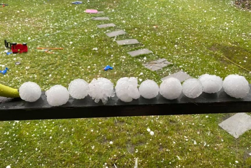 Click to enlarge Huge hail stones lined up on a handrail at a house at Willowbank, west of Brisbane