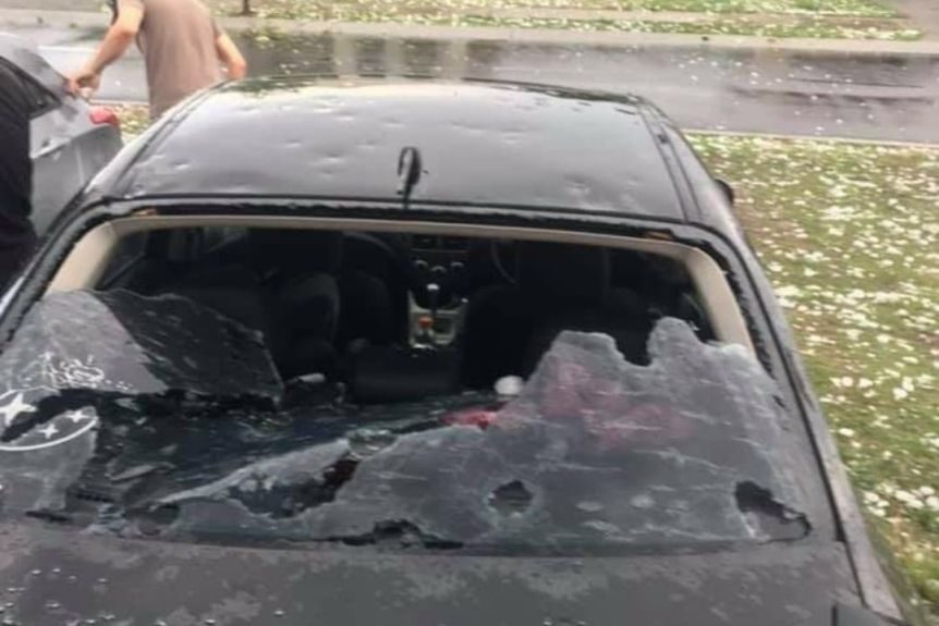 Click to enlarge Hail smashes a car and its windscreen in the storm at Rosewood
