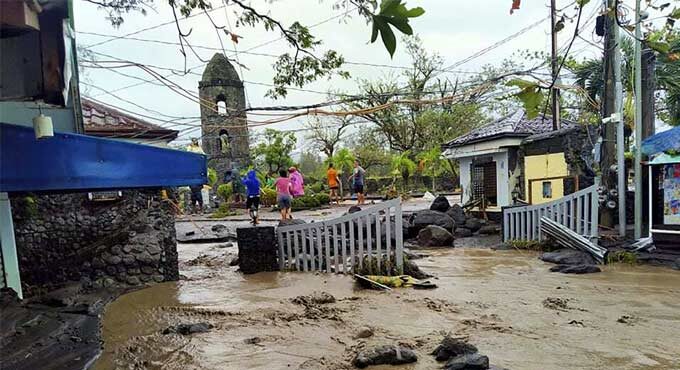 Click to enlarge Floodwaters pass by Cagsawa ruins, a famous tourist spot in Daraga, Albay province, central Philippines as Typhoon Goni hit the area