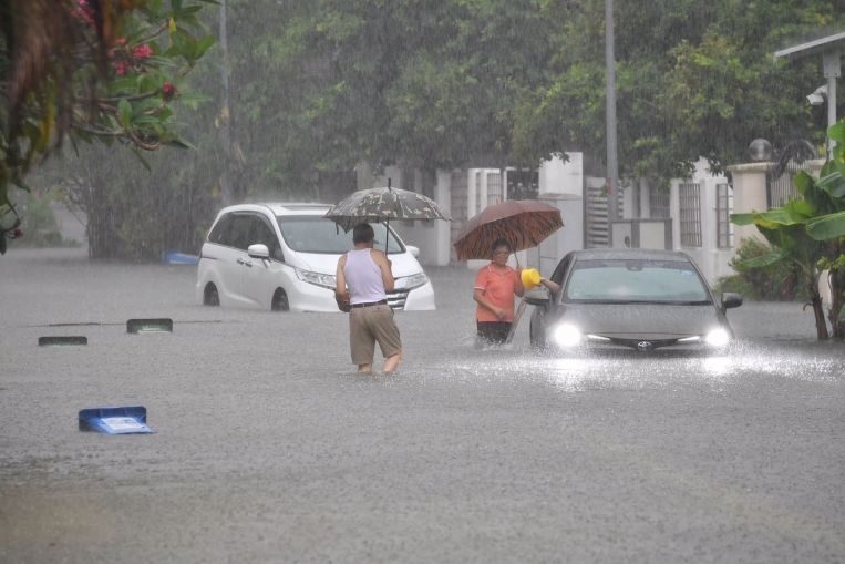 Click to enlarge Two people approach a stranded driver
