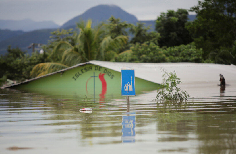 A submerged evangelical church is seen along a flooded street during the passage of Storm Eta, in Pimienta, Honduras November 5, 2020.
