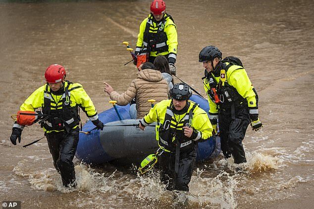 Click to enlarge Firefighters with the Winston-Salem Fire Department evacuate residents at Creekwood Apartments as flood waters rise on Thursday